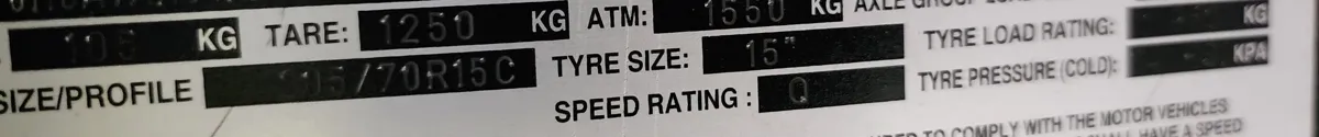 Caravan compliance plate showing the tare of 1250 kg and ATM of 1550 kg